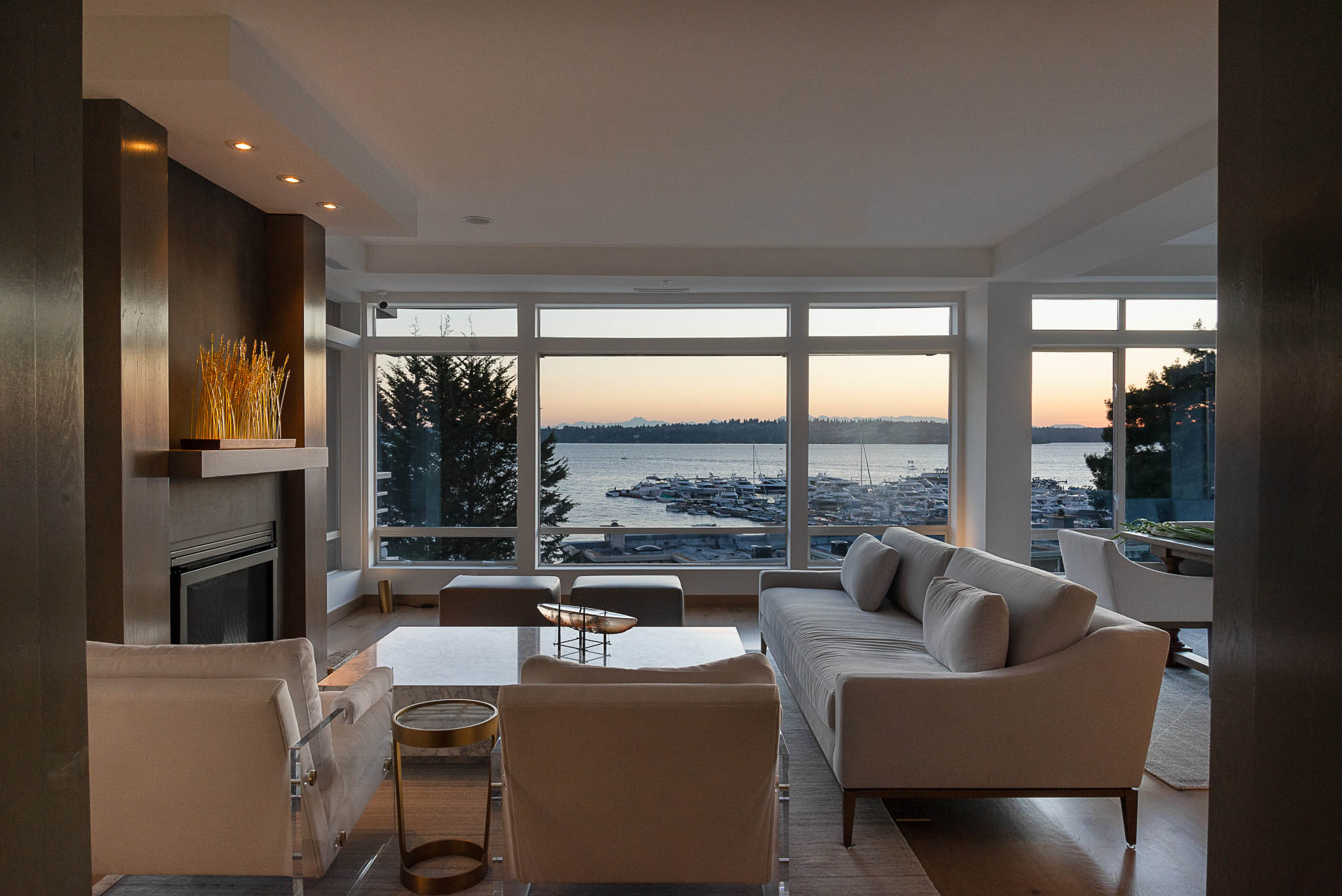 A beautifully remodeled living room with a wide window showcasing a breathtaking water view.