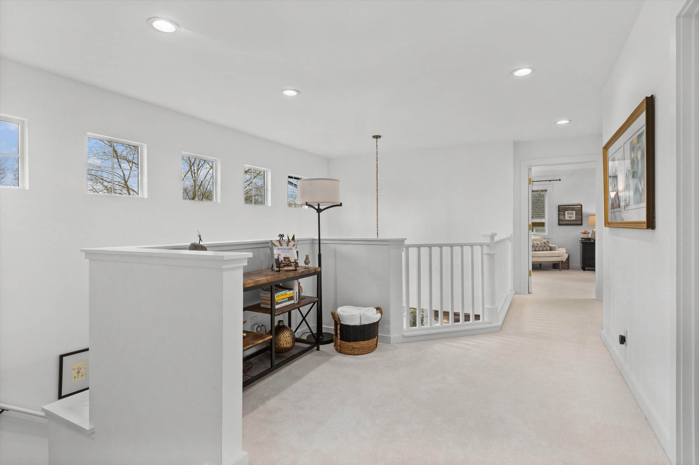 A pristine hallway with white walls and gleaming floors