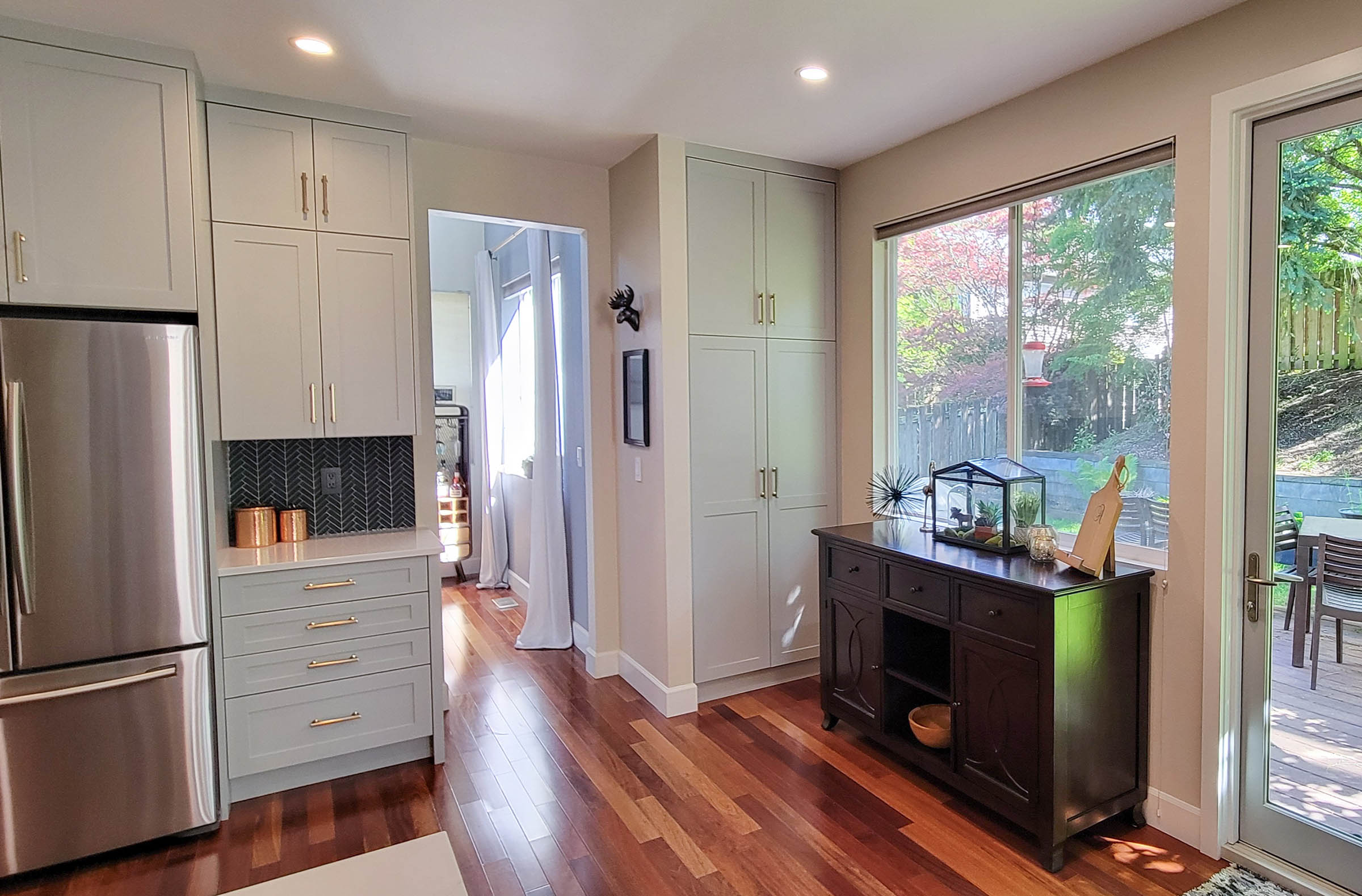 a view from a kitchen to the outdoors